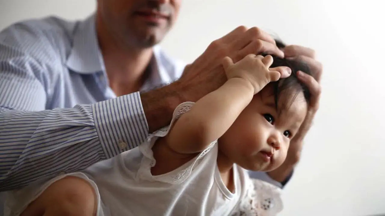 Parent holding their baby during a guided movement exercise